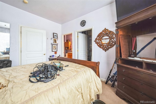 bedroom with carpet floors and connected bathroom