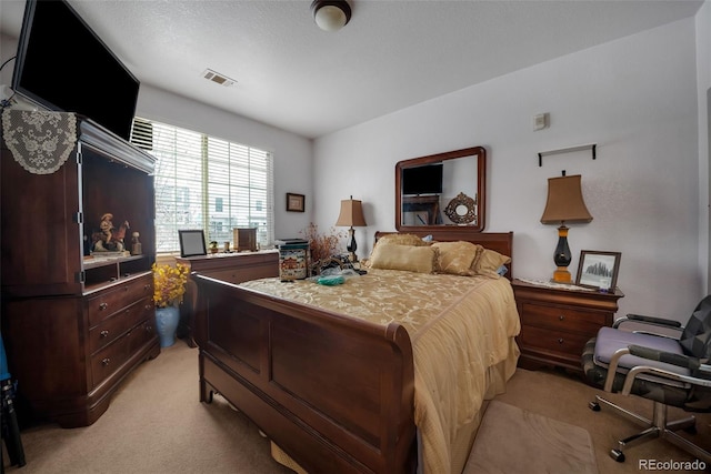 bedroom featuring visible vents and light colored carpet