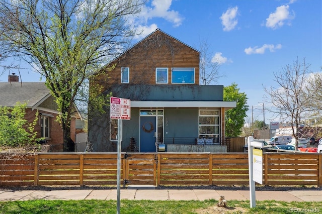 190 W Archer Pl, Denver, CO 80223 - view of front of house with a gate, stucco siding, a porch, and a fenced front yard