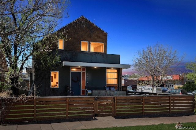 190 W Archer Pl, Denver, CO 80223 - contemporary home with a porch, a fenced front yard, and a balcony