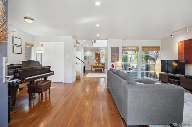 190 W Archer Pl, Denver, CO 80223 - living area featuring light wood-type flooring, recessed lighting, stairs, and track lighting