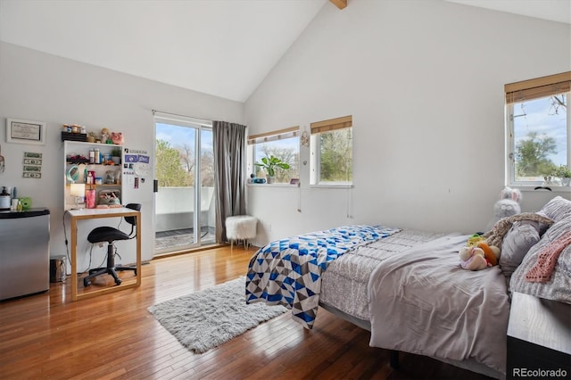 190 W Archer Pl, Denver, CO 80223 - bedroom with stainless steel fridge, high vaulted ceiling, wood finished floors, and access to exterior