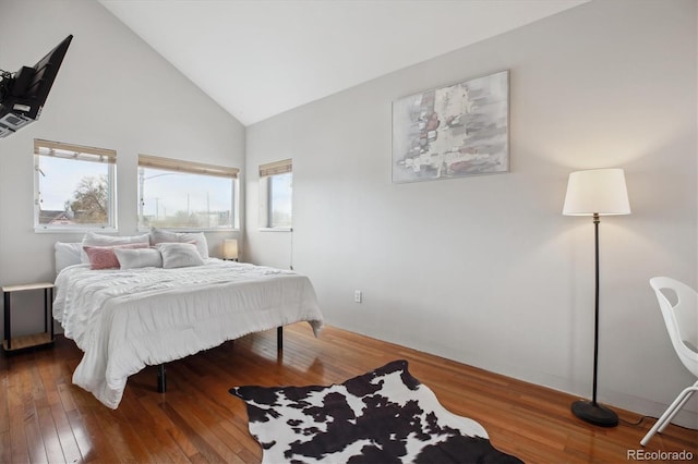 190 W Archer Pl, Denver, CO 80223 - bedroom with wood-type flooring, high vaulted ceiling, and multiple windows