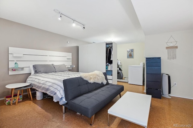 190 W Archer Pl, Denver, CO 80223 - bedroom with a closet, rail lighting, washer / dryer, and baseboards