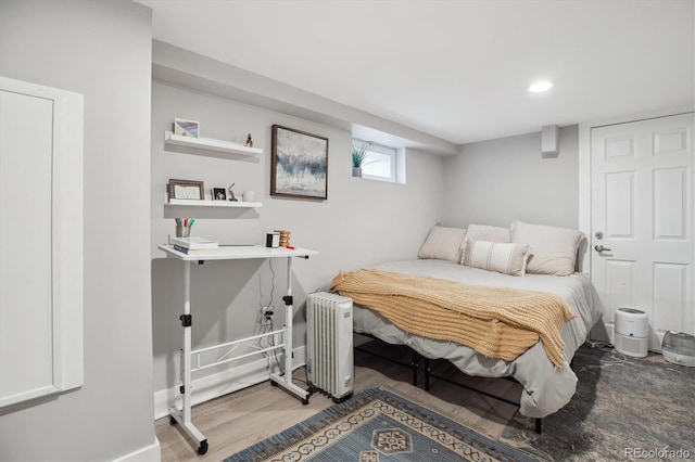 190 W Archer Pl, Denver, CO 80223 - bedroom with radiator heating unit, baseboards, recessed lighting, and wood finished floors