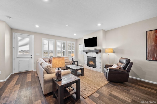 4475 Hidden Gulch Rd, Castle Rock, CO 80104 - living area with a glass covered fireplace, baseboards, dark wood-style flooring, and recessed lighting