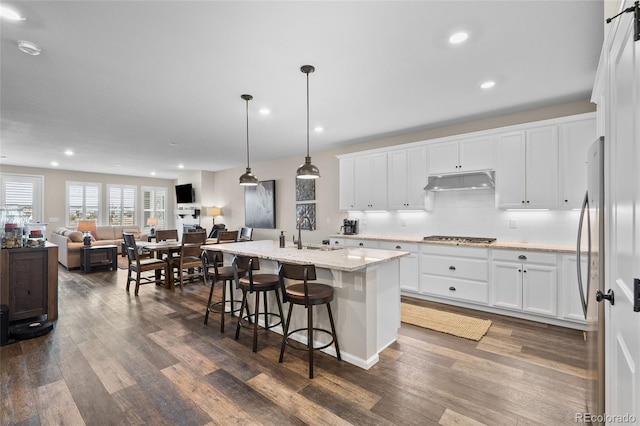 4475 Hidden Gulch Rd, Castle Rock, CO 80104 - kitchen featuring under cabinet range hood, a sink, appliances with stainless steel finishes, dark wood-type flooring, and open floor plan