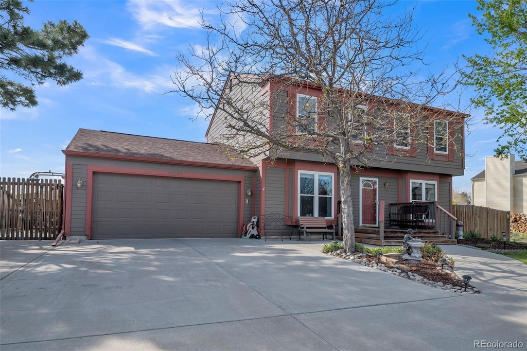 11321 N Brownstone Dr, Parker, CO 80138 - view of front of home with fence, concrete driveway, and a garage