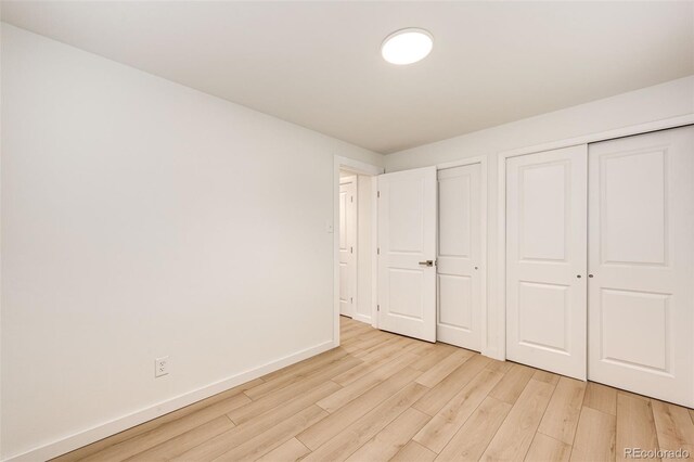 5780 W 5th Ave, Lakewood, CO 80226 - unfurnished bedroom featuring light wood-type flooring and baseboards