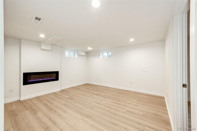 5780 W 5th Ave, Lakewood, CO 80226 - below grade area featuring light wood-style floors, recessed lighting, and a glass covered fireplace