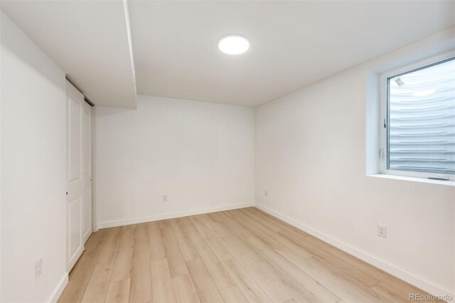 5780 W 5th Ave, Lakewood, CO 80226 - unfurnished bedroom featuring light wood finished floors and baseboards