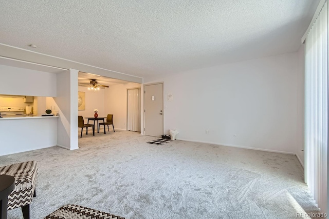 carpeted empty room featuring a textured ceiling