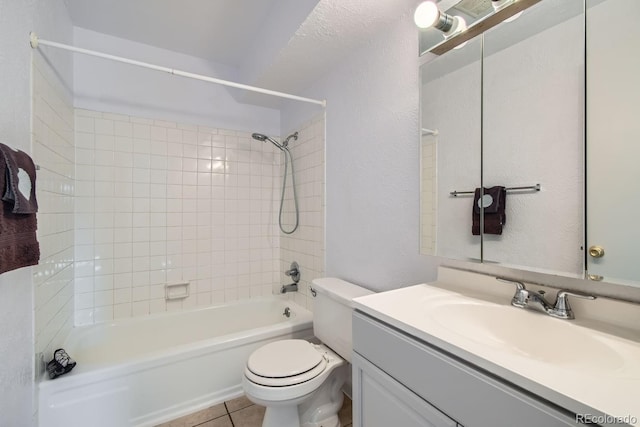 full bathroom featuring vanity, tile patterned flooring, tiled shower / bath combo, and toilet