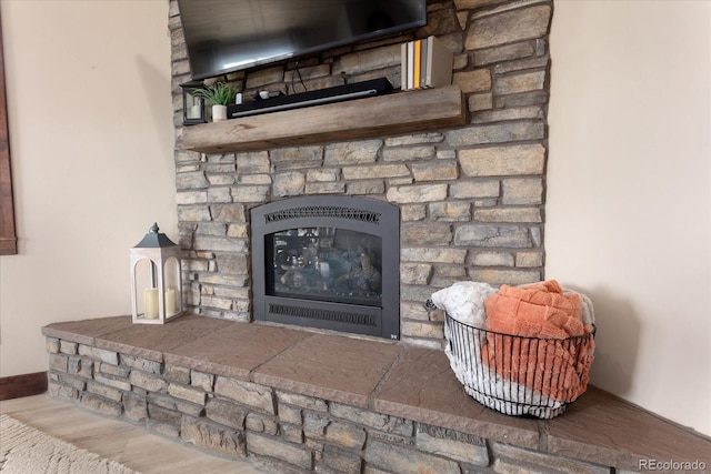 details with a fireplace and wood finished floors