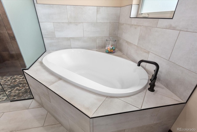 bathroom with a bath and tile patterned floors