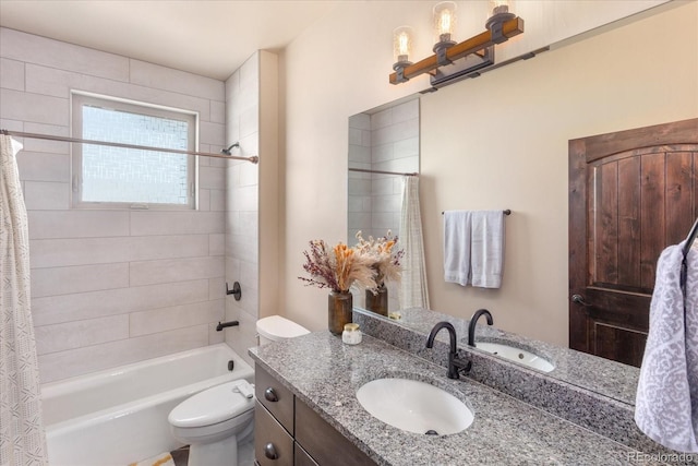 full bath featuring toilet, vanity, and shower / bath combination with curtain