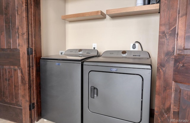 laundry room featuring washing machine and clothes dryer and laundry area