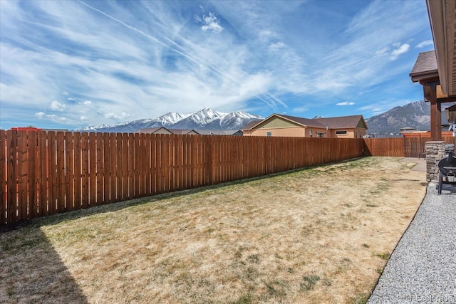 view of yard with a mountain view and a fenced backyard