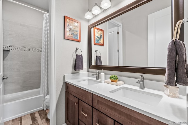 9028 S Catawba St, Aurora, CO 80016 - bathroom with double vanity, shower / bath combo with shower curtain, and toilet