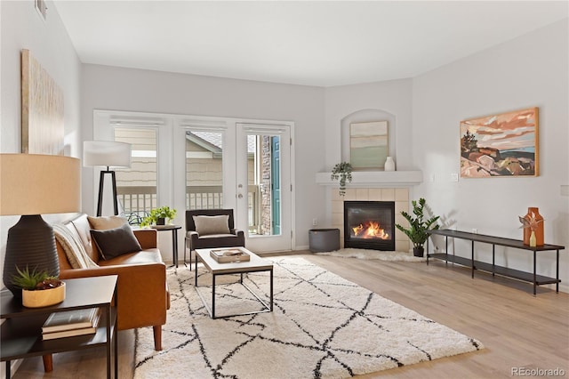 4385 S Balsam St Unit 5-104, Littleton, CO 80123 - living room with a tiled fireplace and wood finished floors