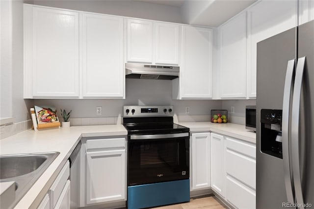 4385 S Balsam St Unit 5-104, Littleton, CO 80123 - kitchen with appliances with stainless steel finishes, under cabinet range hood, white cabinetry, and light countertops