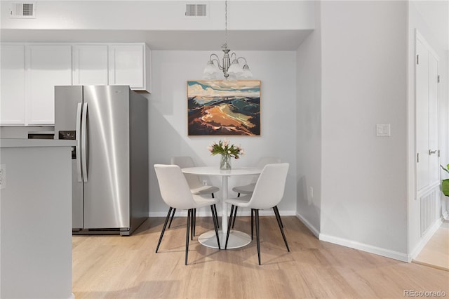 4385 S Balsam St Unit 5-104, Littleton, CO 80123 - dining room featuring a chandelier and light wood-style floors