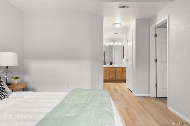 4385 S Balsam St Unit 5-104, Littleton, CO 80123 - bedroom featuring light wood-style floors and ensuite bath
