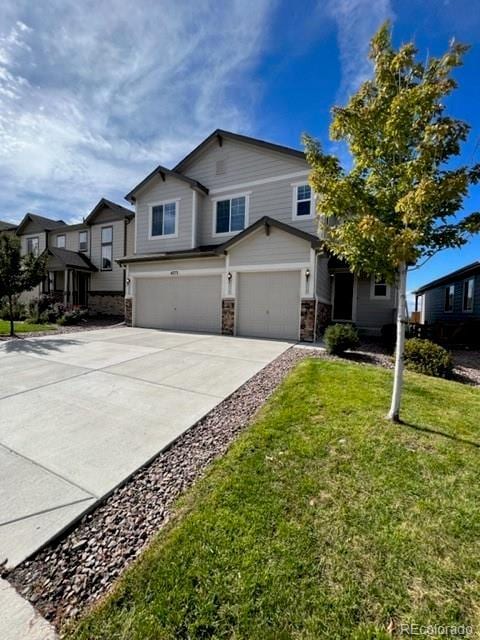 view of front of house with a garage and a front lawn