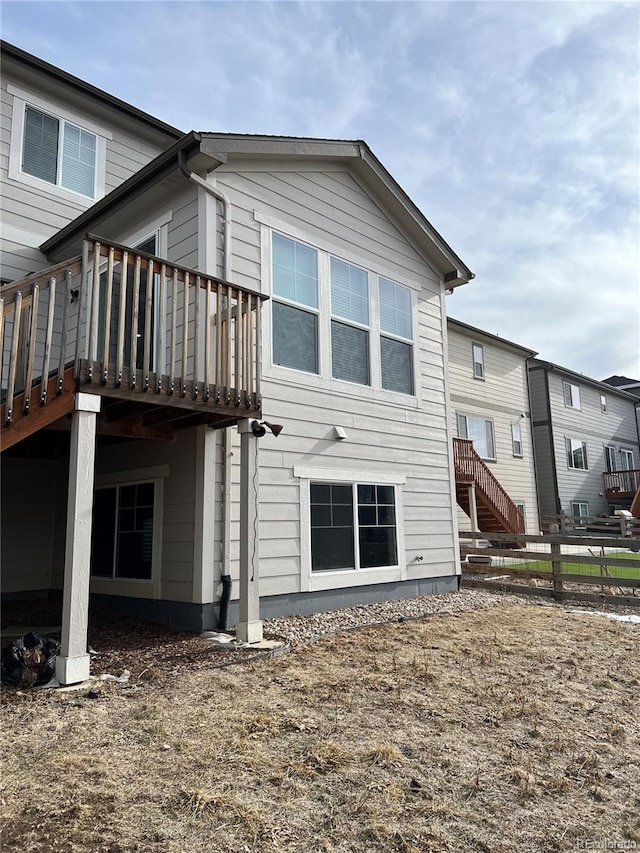 back of house featuring a wooden deck