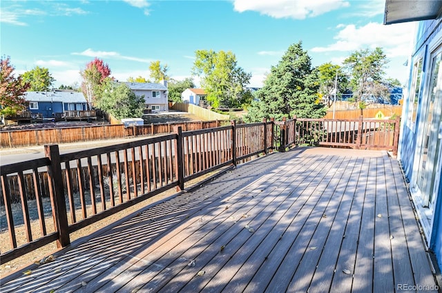 deck with a residential view and a fenced backyard