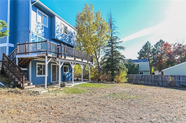 back of property featuring a patio area, stairs, a deck, and fence