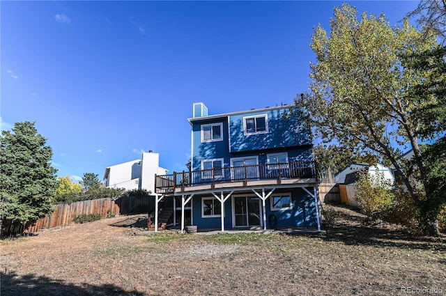 rear view of house featuring stairway, a fenced backyard, and a wooden deck