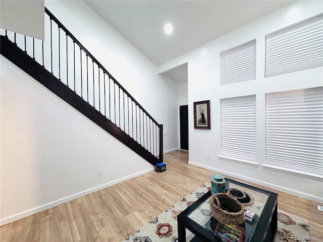 interior space featuring recessed lighting, stairway, baseboards, and wood finished floors