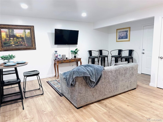 living area with recessed lighting and light wood-style flooring