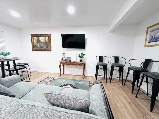 living area featuring recessed lighting, baseboards, and wood finished floors