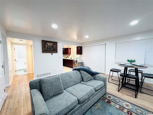 living area with visible vents, recessed lighting, baseboards, and light wood-style floors