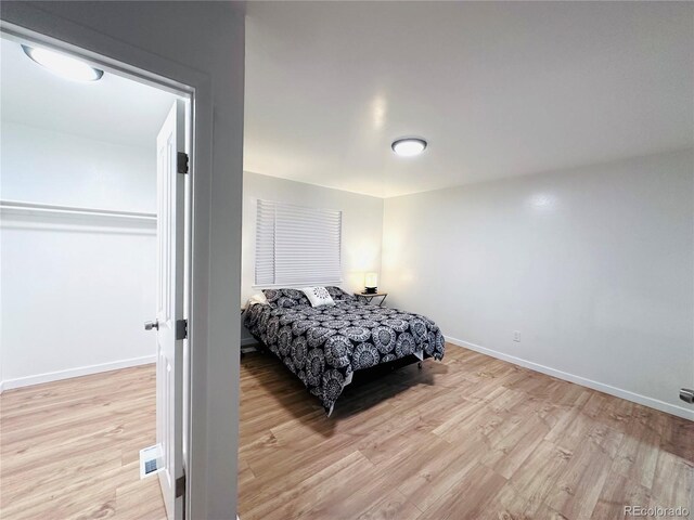 bedroom with visible vents, baseboards, and light wood-style flooring