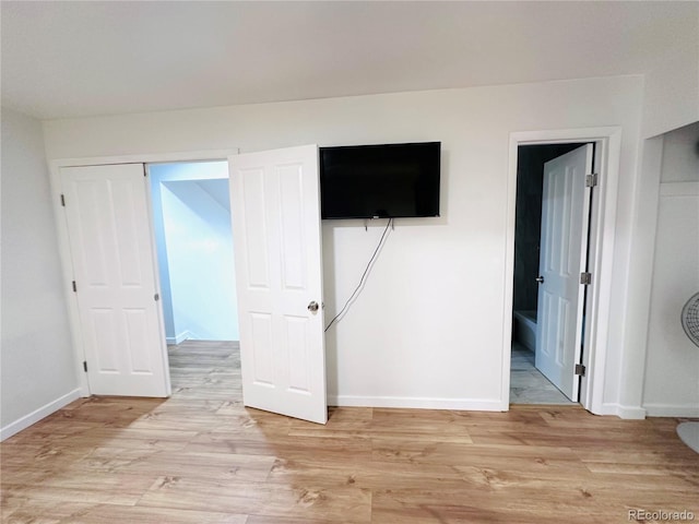 unfurnished bedroom with baseboards and light wood finished floors