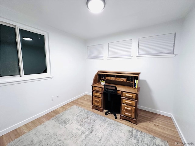 office area with wood finished floors and baseboards