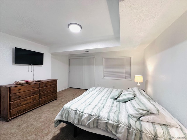 bedroom with carpet floors and a textured ceiling