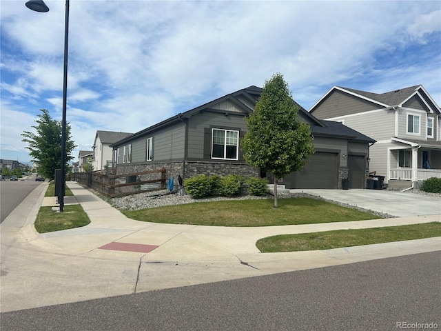view of front of house featuring stone siding, driveway, and a garage