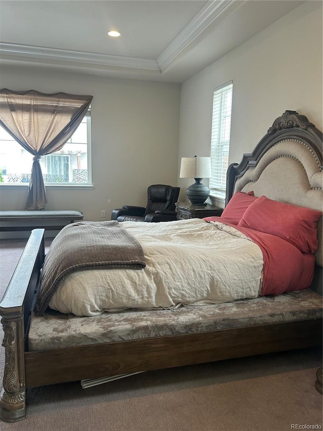 carpeted bedroom featuring crown molding, a tray ceiling, and recessed lighting