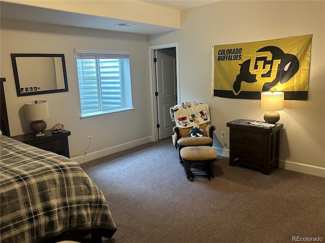 bedroom featuring carpet and baseboards