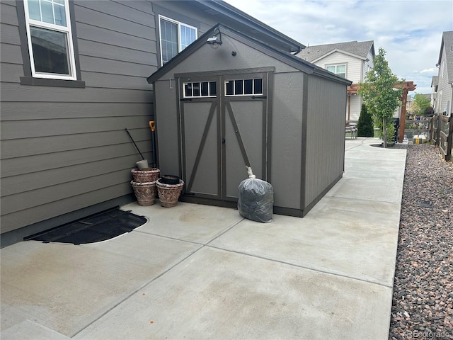 view of shed featuring fence