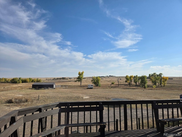 wooden deck with a rural view