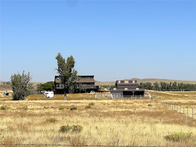 view of yard with a mountain view and a rural view