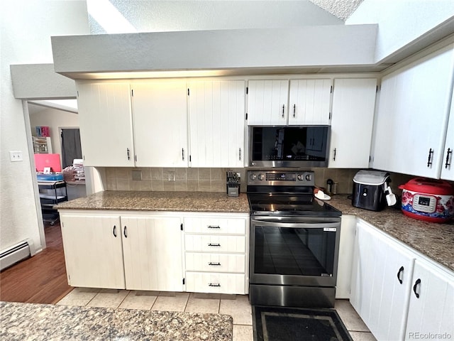 kitchen with white cabinets, backsplash, light tile patterned flooring, and stainless steel appliances