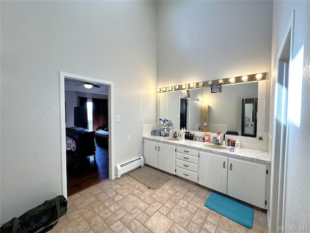 bathroom featuring vanity and baseboard heating