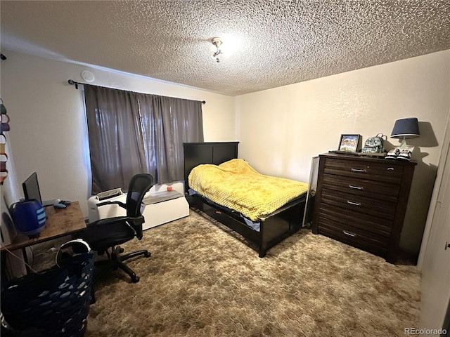 bedroom featuring carpet floors and a textured ceiling