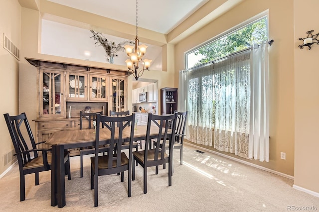 9229 Sugarstone Cir, Highlands Ranch, CO 80130 - dining space with a chandelier, light carpet, baseboards, and a high ceiling